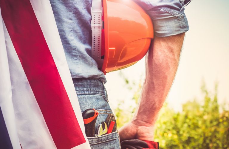 Construction Worker Holding Hard Hat with American Flag