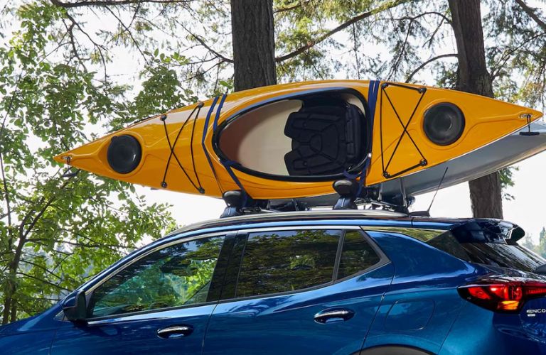 side view of the 2023 Buick Encore GX carrying a boat