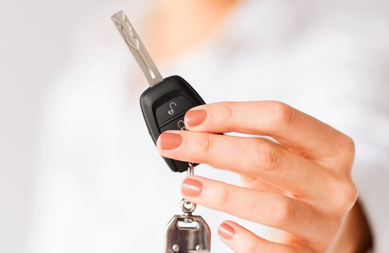 a woman holding a car key
