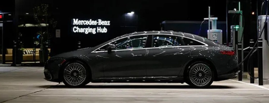 A Mercedes-Benz sedan at a Mercedes-Benz charger
