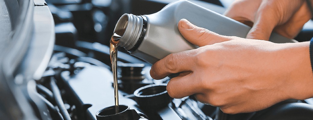 fresh oil being poured in a vehicle