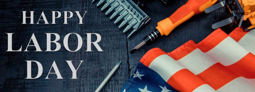 American Flag and Tools on Table with White Happy Labor Day Text