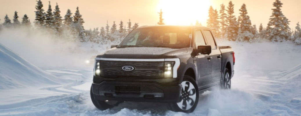 The 2025 Ford F-150 Lightning driving in heavy snow