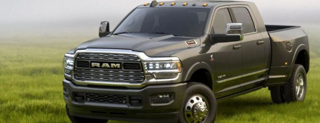 One green color 2023 Ram 3500 is parked on the grass.