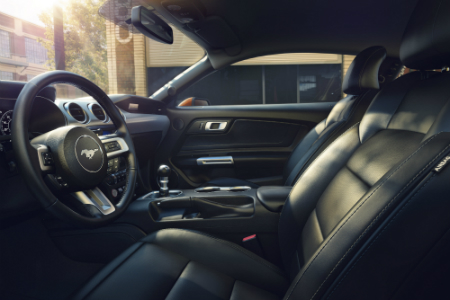 side view of front interior of 2018 ford mustang including seats, steering wheel and center console