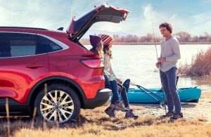 Friends talking while sitting on the cargo of the 2020 Ford Escape