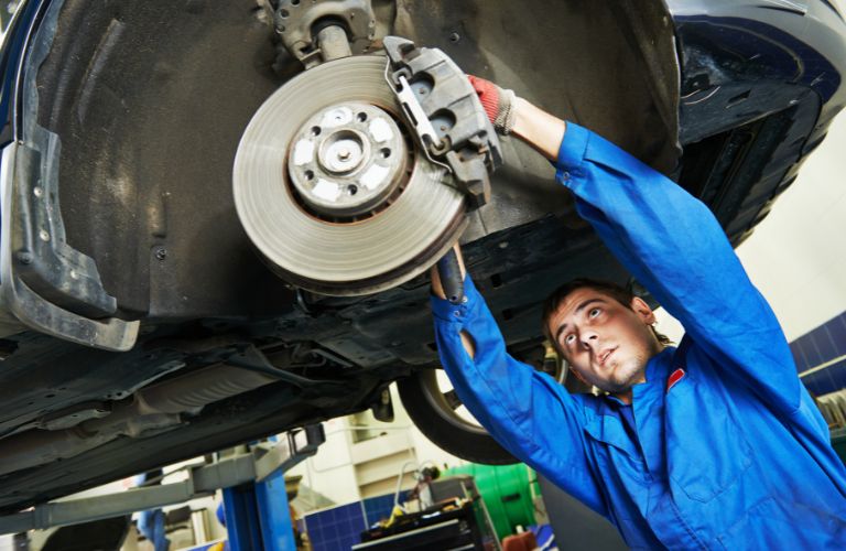 a technician fixing the brakes of a vehicle