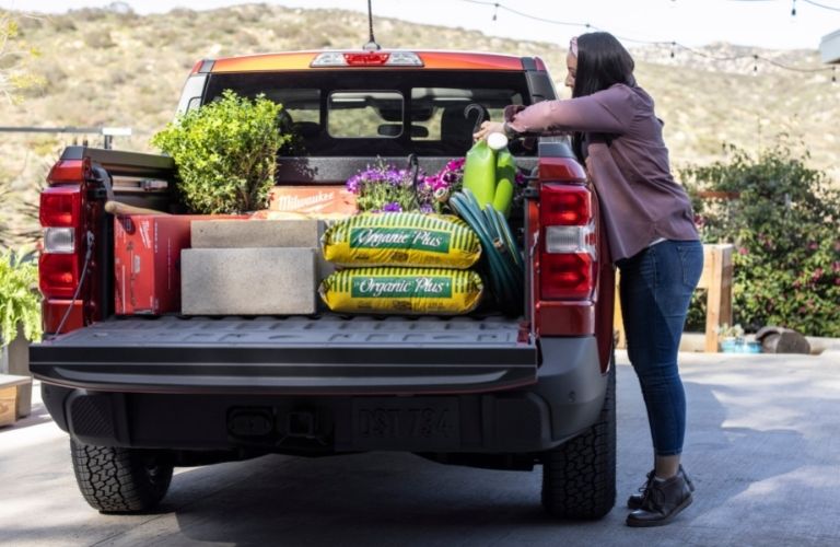 Woman loading the cargo of the 2022 Ford Maverick