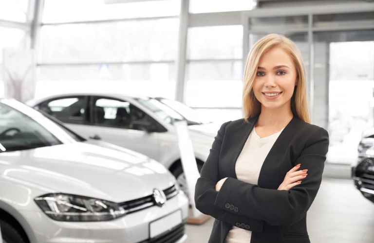Sales woman posing with the vehicles