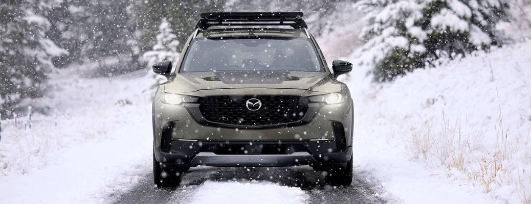 Front view of a 2024 Mazda CX-50 on a snowy road