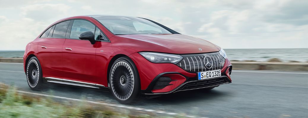 One red color 2023 Mercedes-Benz EQE is running on the road.