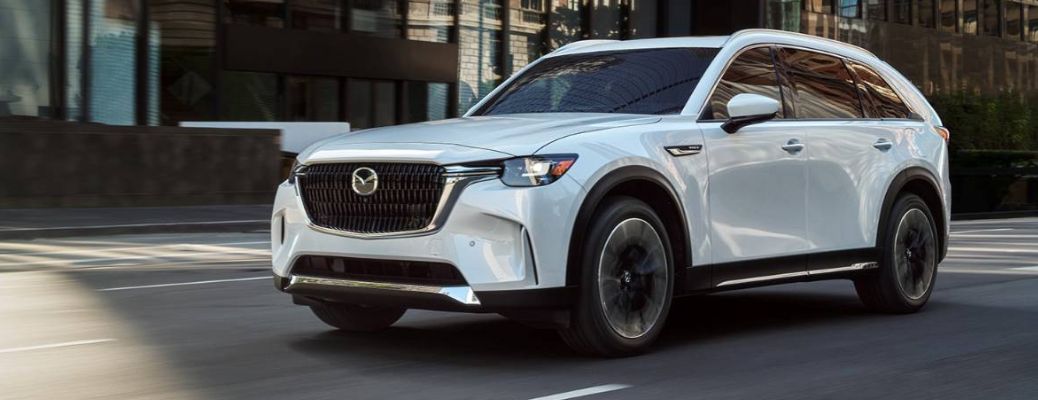Front three-quarter view of the 2024 Mazda CX-90 PHEV driving on road