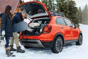 People loading supplies into the trunk of 2020 Fiat 500X Trekking Plus