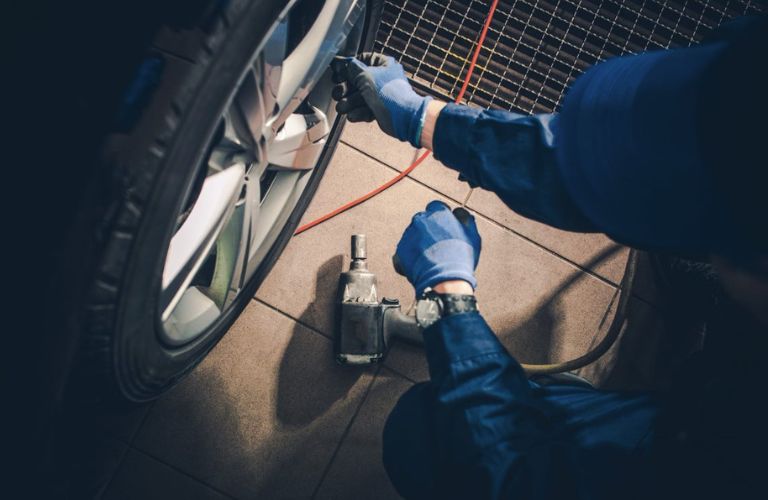 A man working on tires of a vehicle