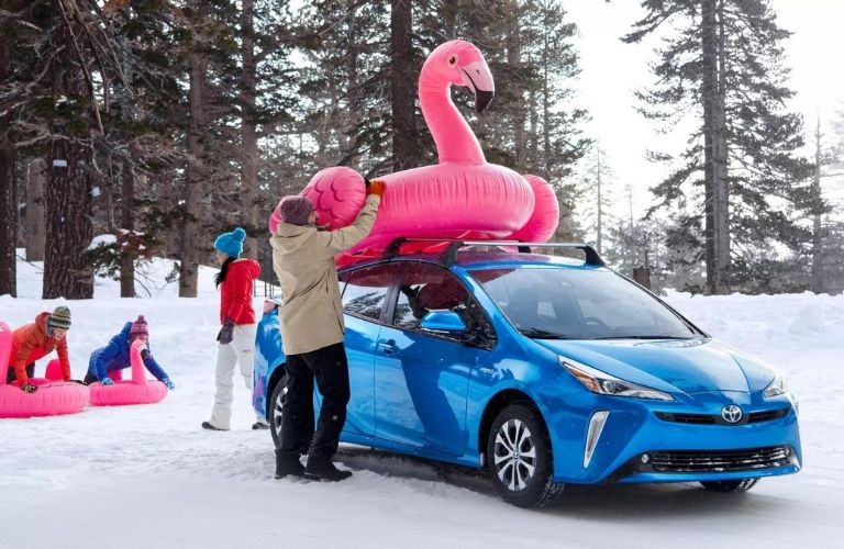 A family with a car in the snow