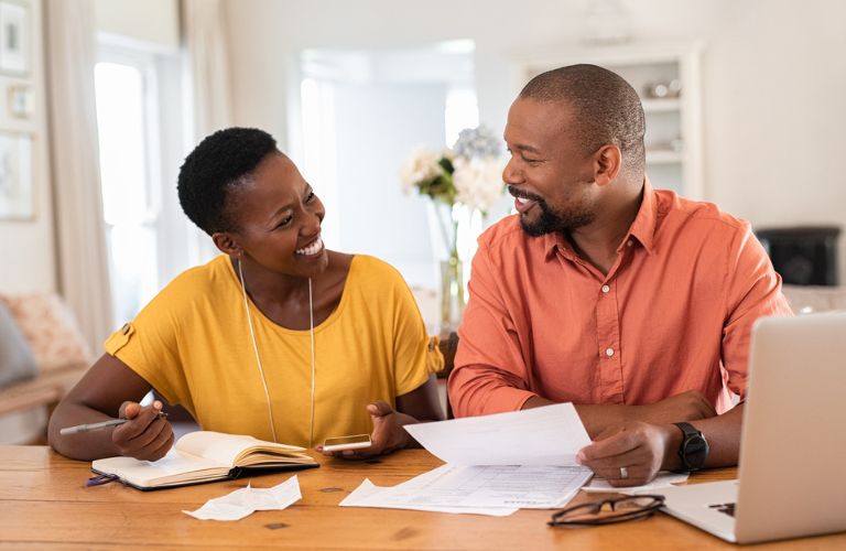 A smiling couple with papers