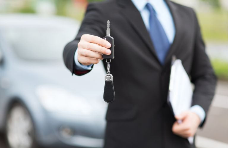 Hands of a man showing car keys