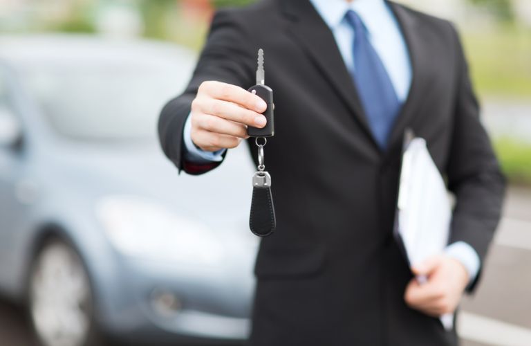 A man holding car keys