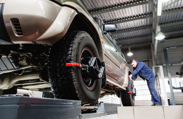 Technician checking a vehicle's wheel