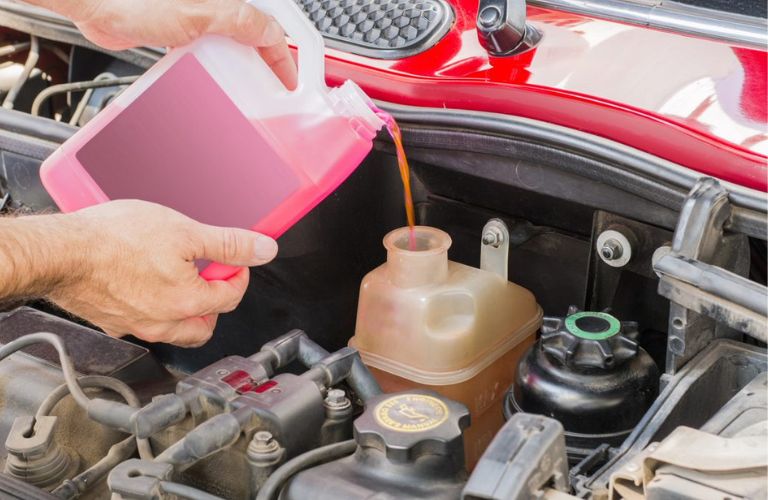 Mechanic changing vehicle oil