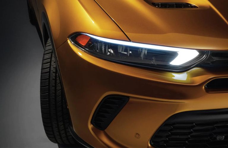 Front light of a yellow color 2023 Dodge Hornet is shown.