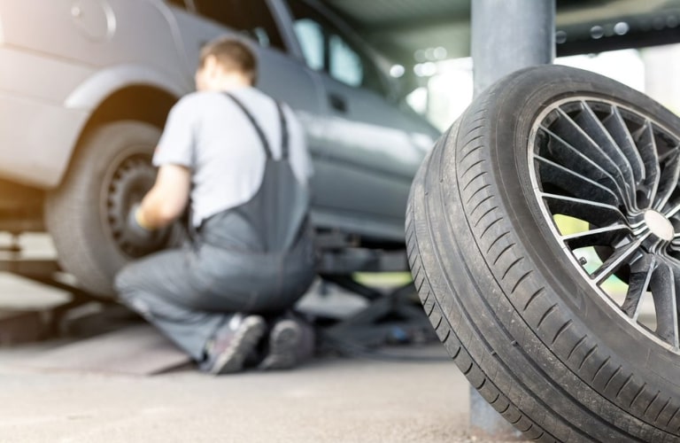 Service professional checking a vehicle's tire
