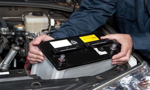 Mechanic installing a new car battery