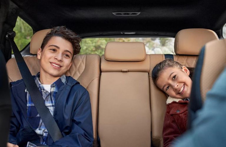 Kids with seatbelt inside the 2023 Hyundai Santa Fe