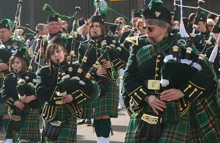 bagpipers dressed in green