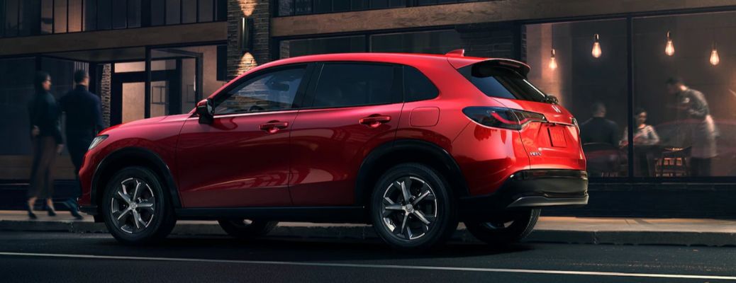 One red color 2024 Honda HR-V is running on the road.