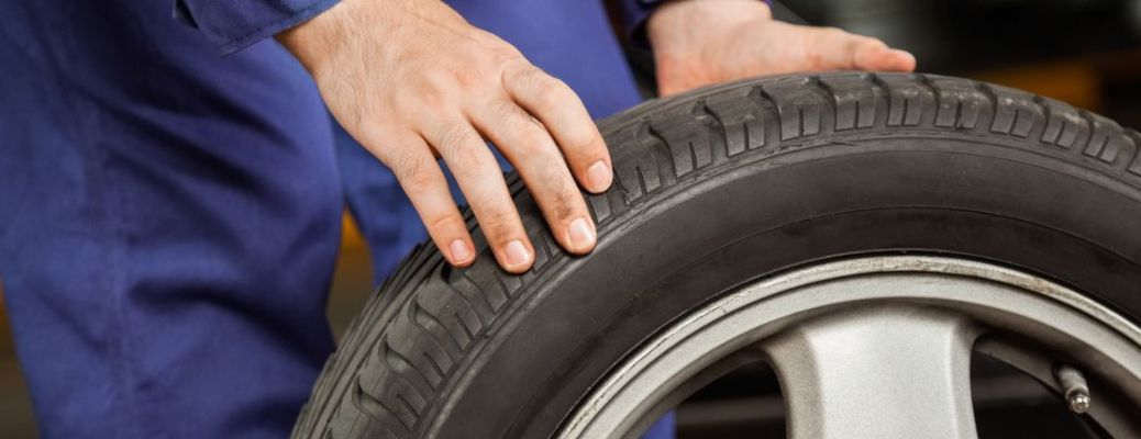 Technician inspecting a tire